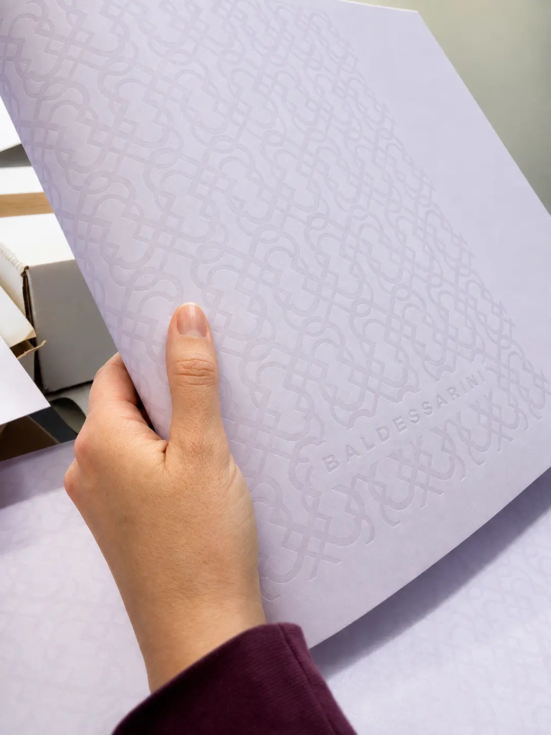 Embossed Baldessarini pattern on coloured-through board